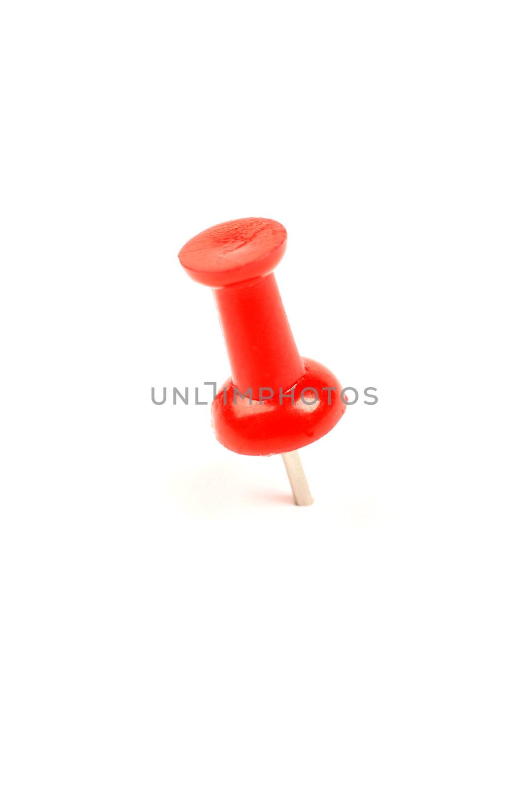 Macro of red drawing pin isolated on white background.