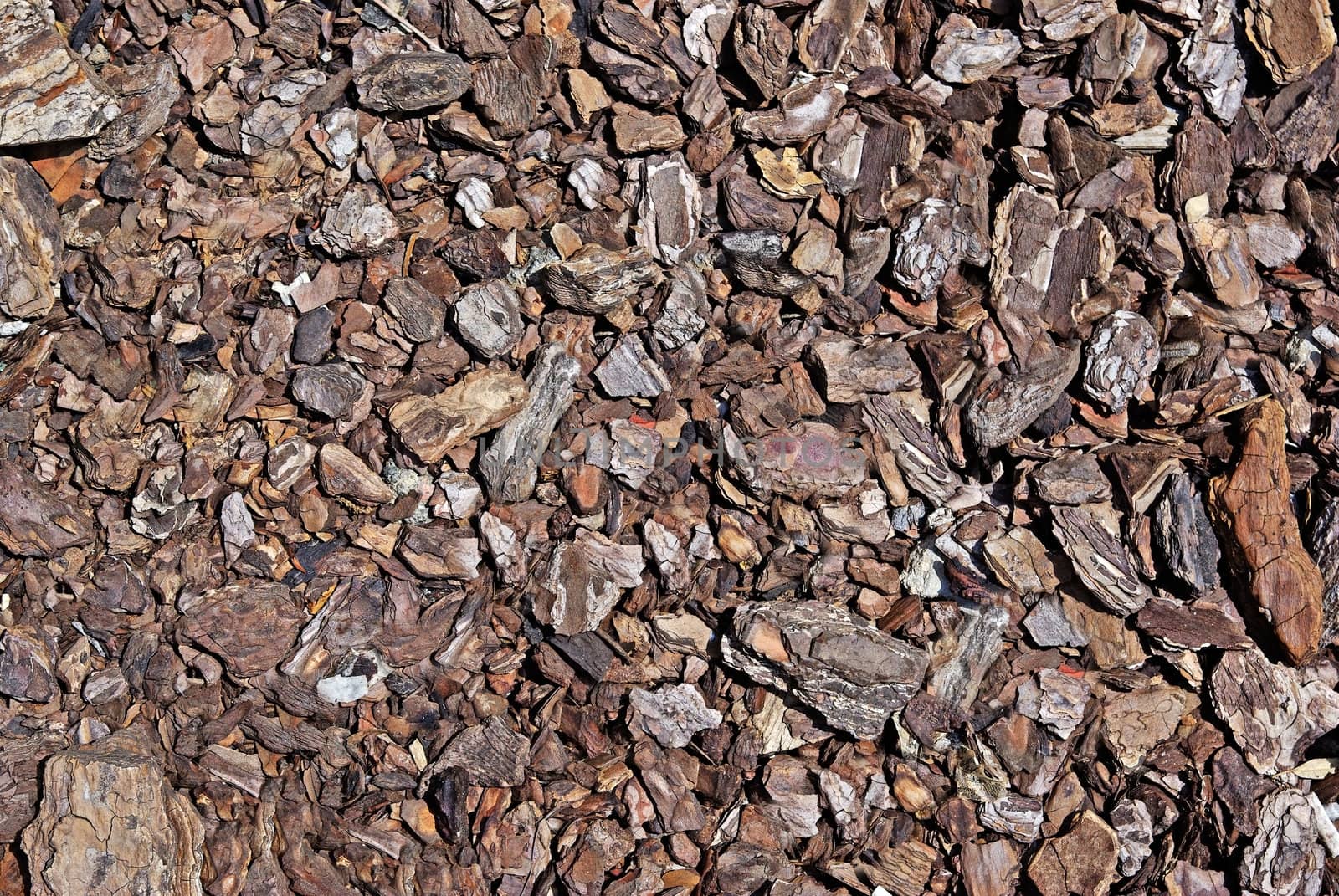 Shredded brown bark as decoration for garden. Good as background by borodaev