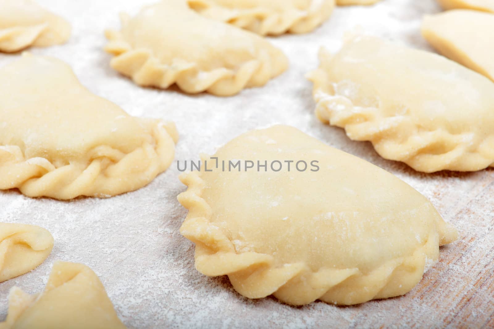 Close up shot of dumplings during prepare process. by borodaev