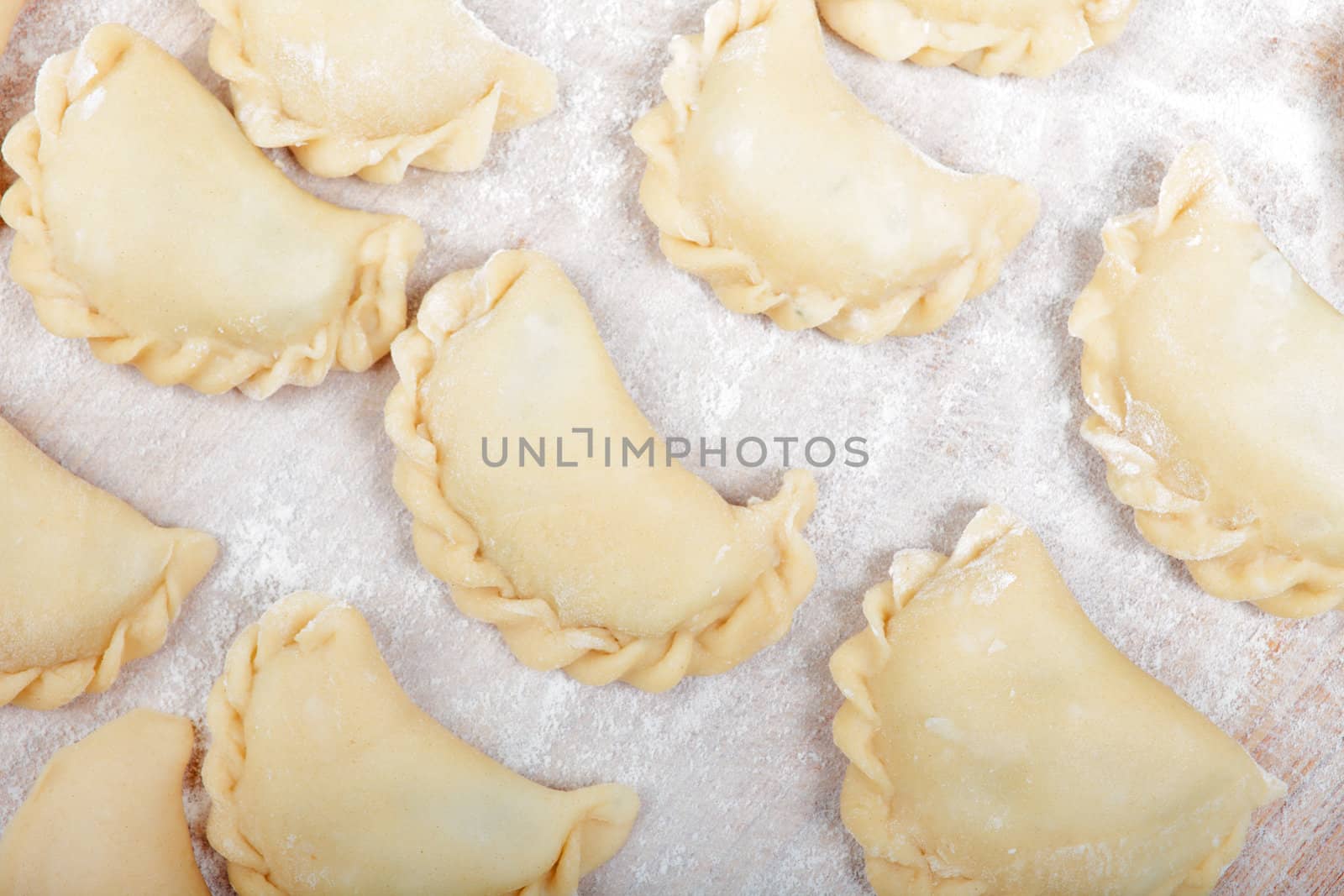 Close up shot of dumplings during prepare process. by borodaev