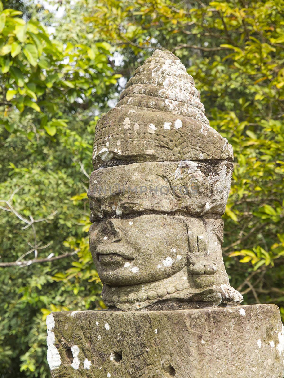 The ancient stone statue of Khmer god on the south gate of Angkor Thom, the world heritage site in Siem Reap province, Cambodia