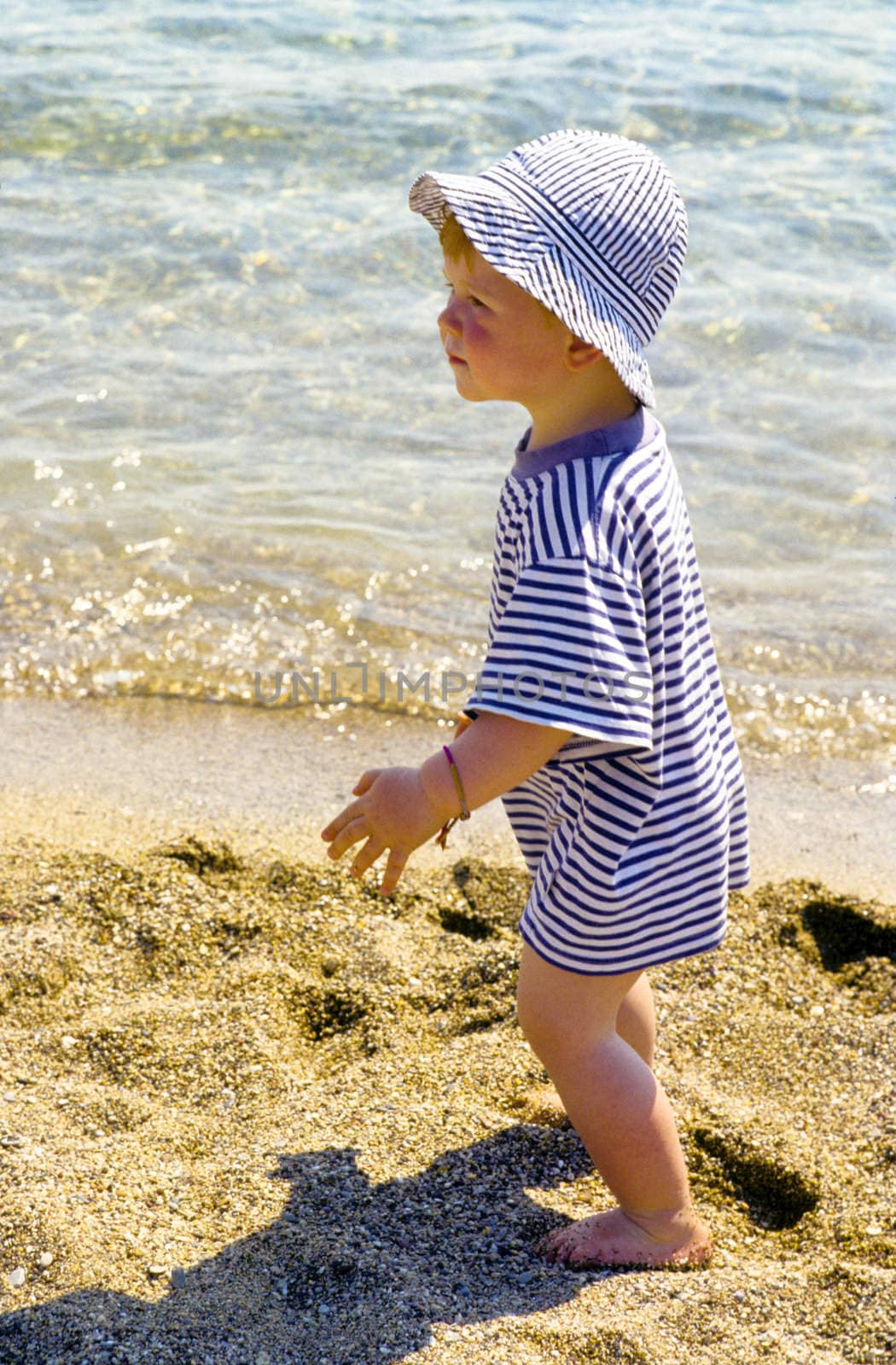 cute young child boy enjoys the beach