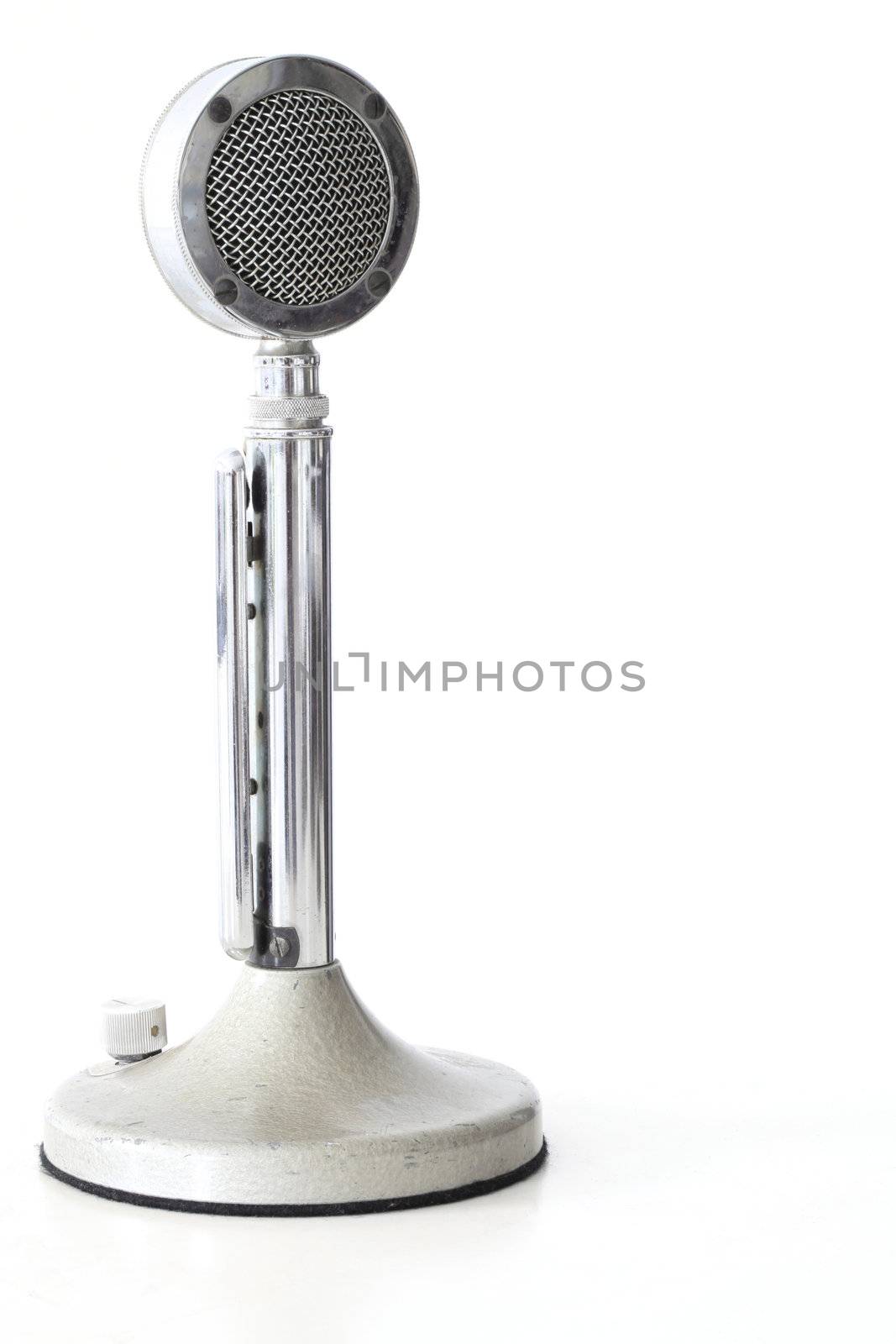 retro Microphone on white table with its reflection