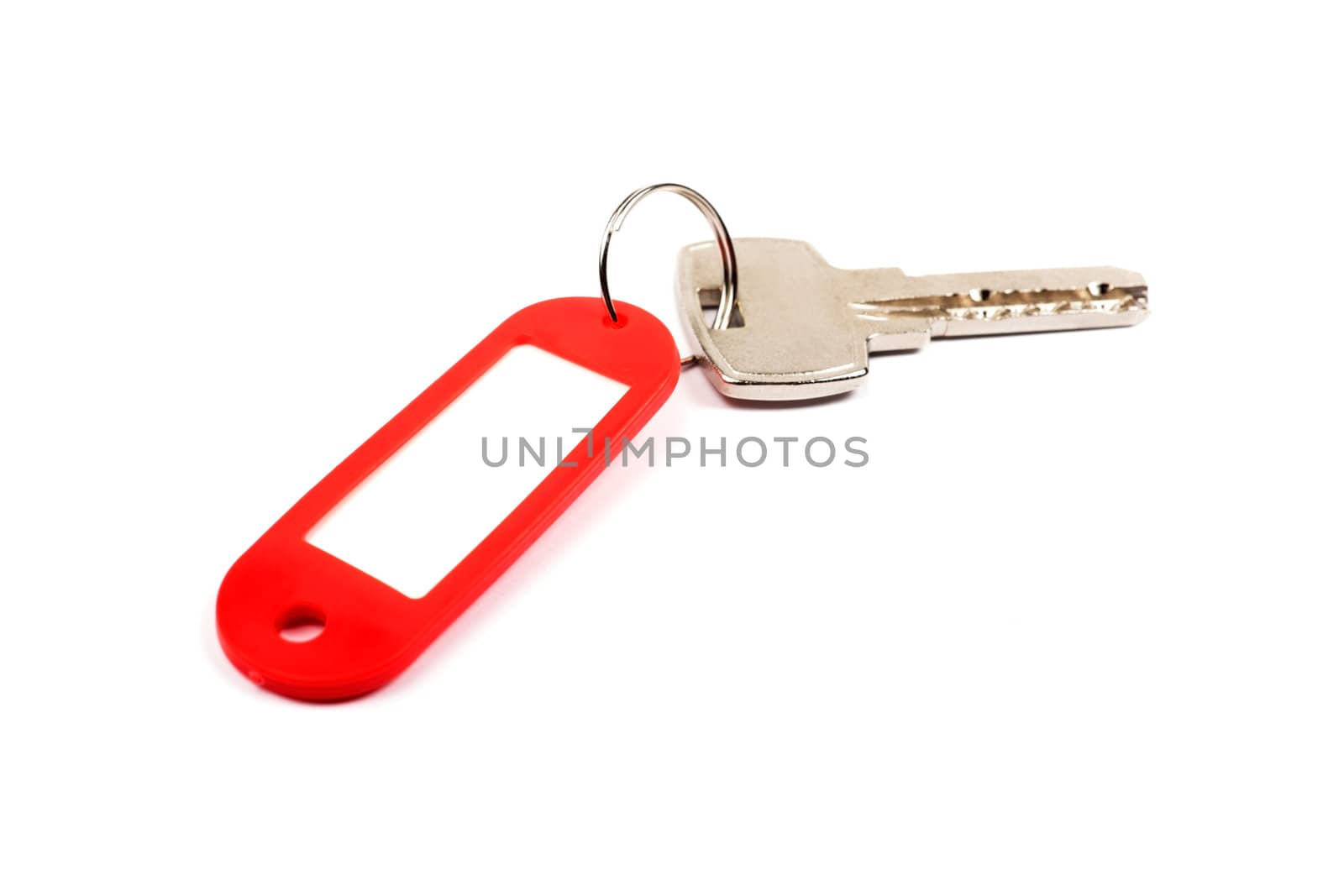 Key and red trinket with empty for your design space isolated on white background.