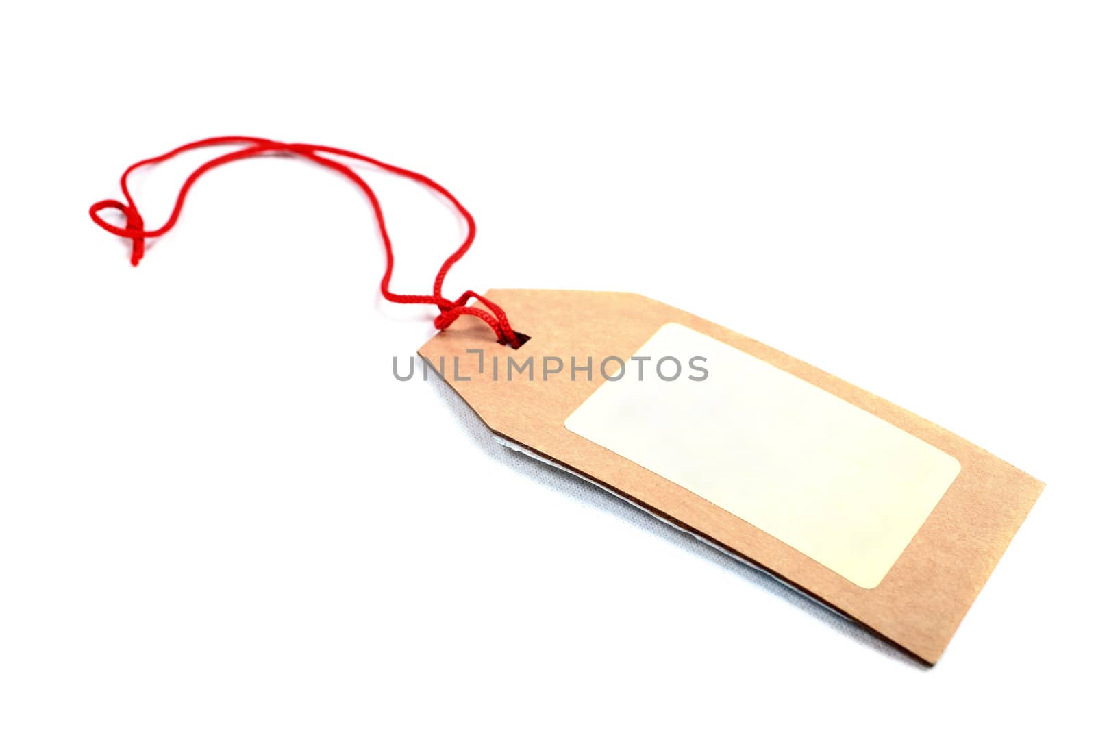 Price tag made of brown cardboard with red rope isolated on white background.