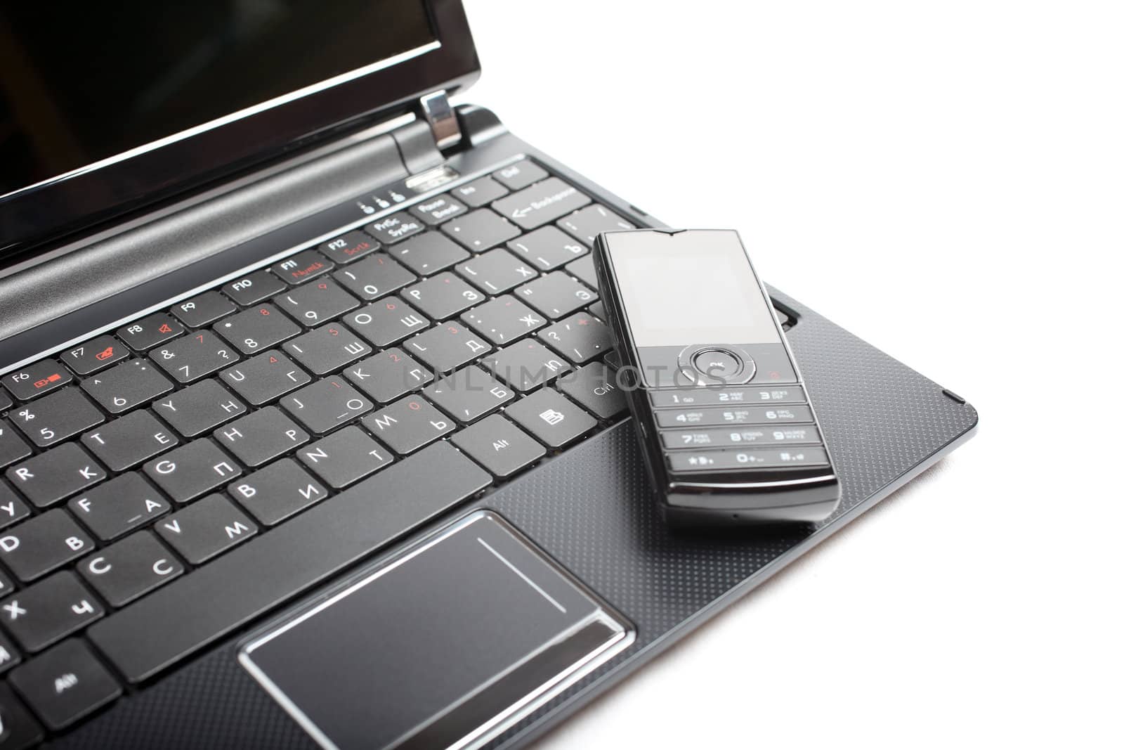 Netbook and mobile phone isolated on the white background.