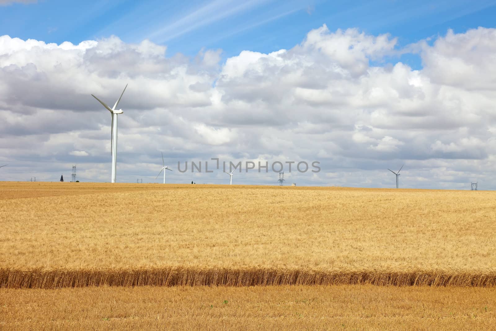 French field with wind power generators, Europe.