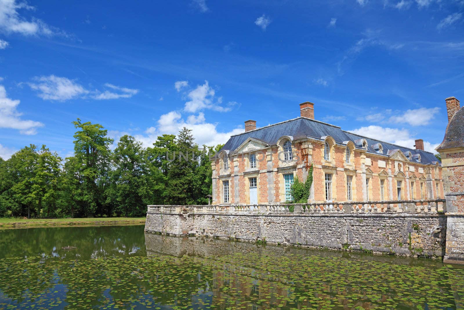 Old french mansion with a lake nearby, Europe. by borodaev