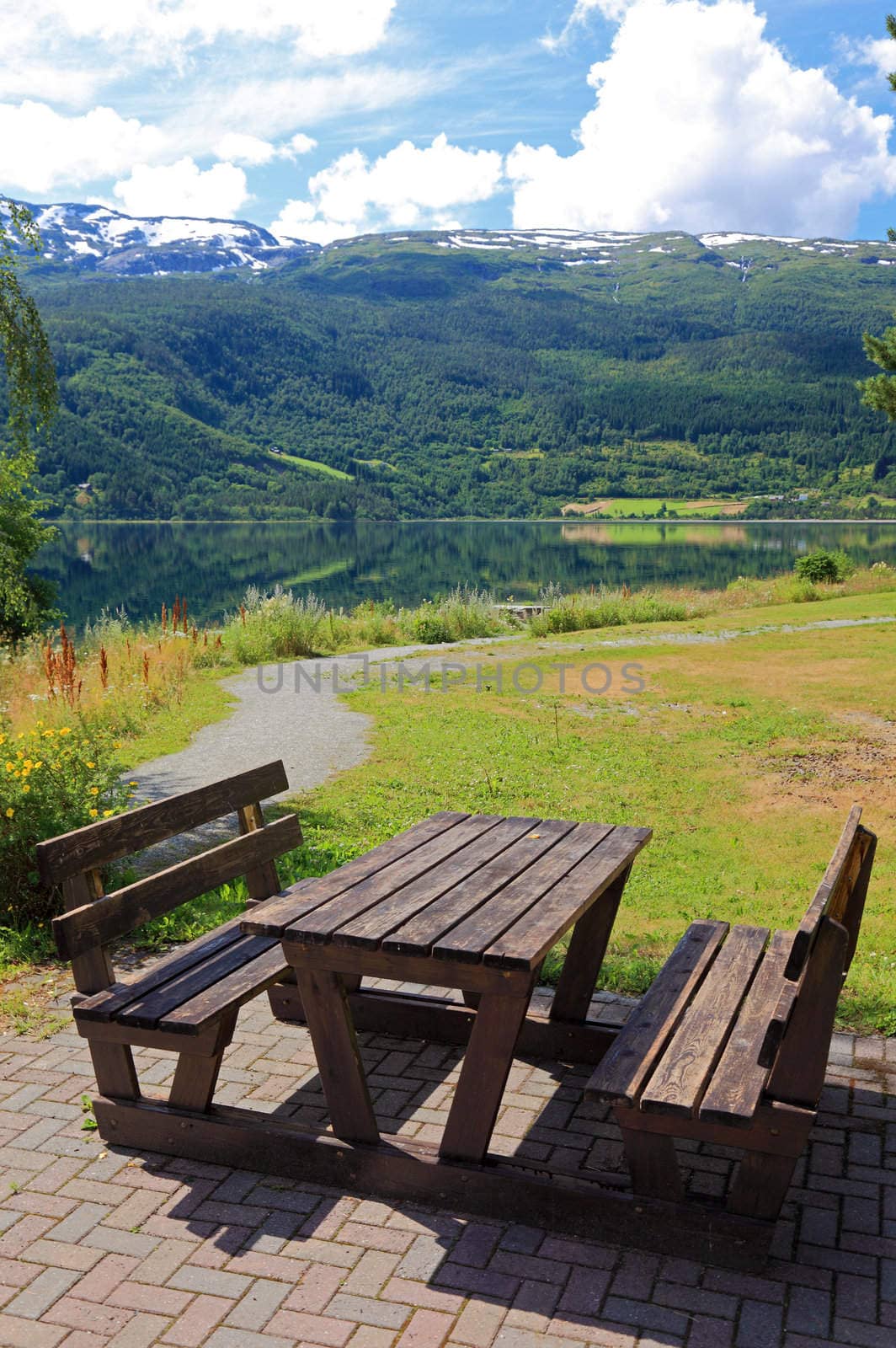Picnic table and benches near lake in Norway, Europe. by borodaev