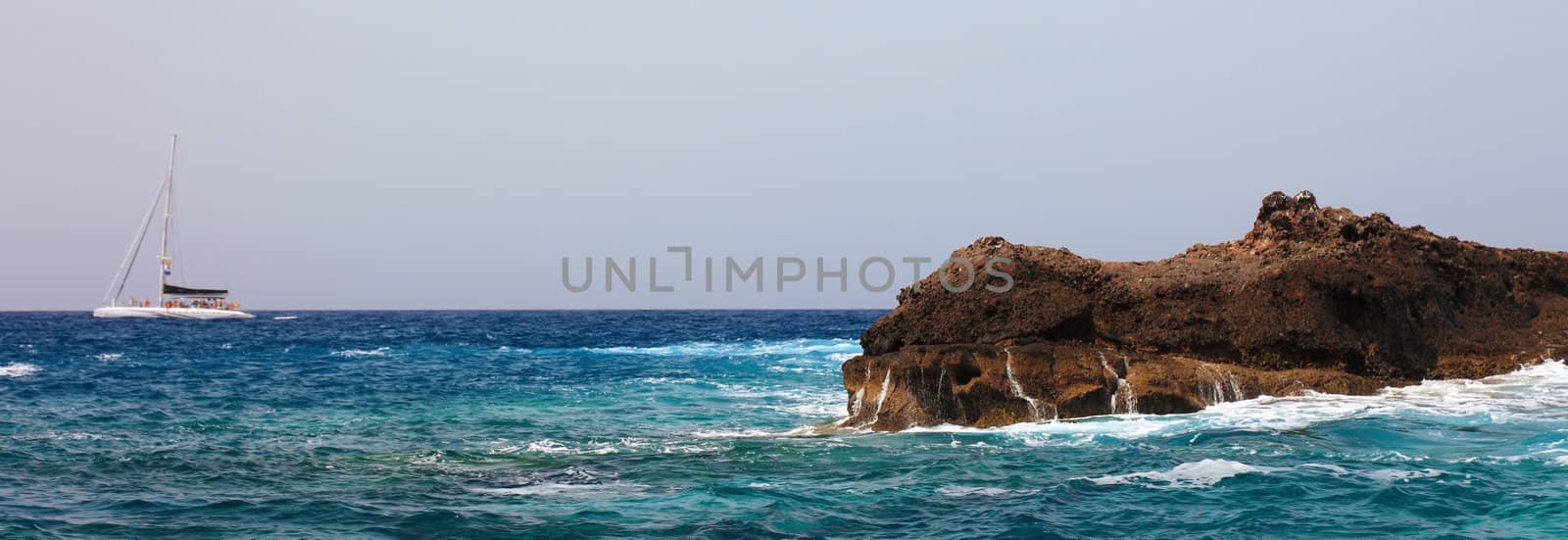 Panoramic view of sailing boat and rock near Tenerife, Canary Islands.