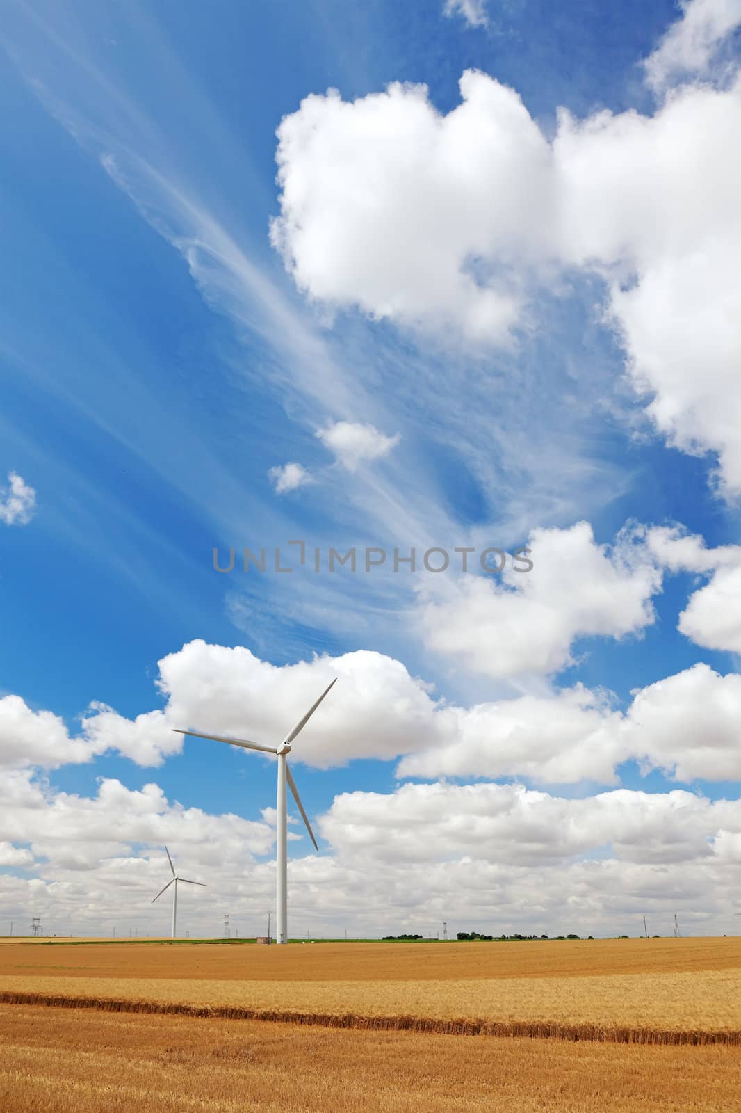 French field with wind power generators, Europe.