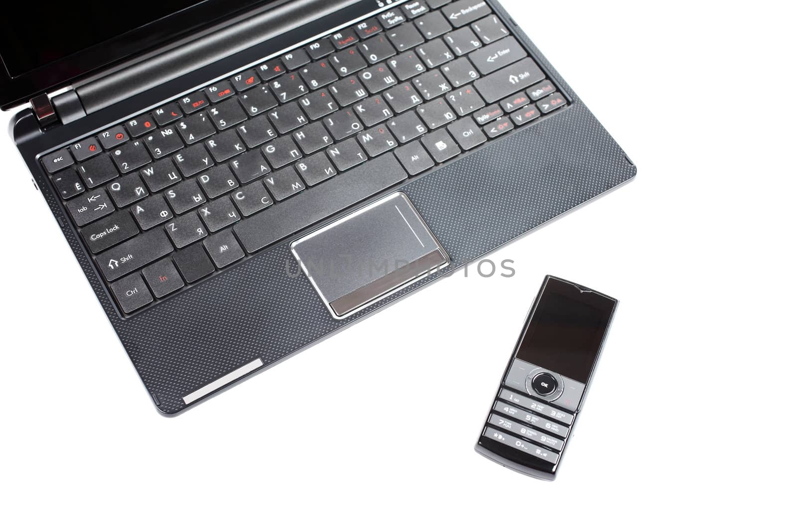 Netbook and mobile phone isolated on the white background.