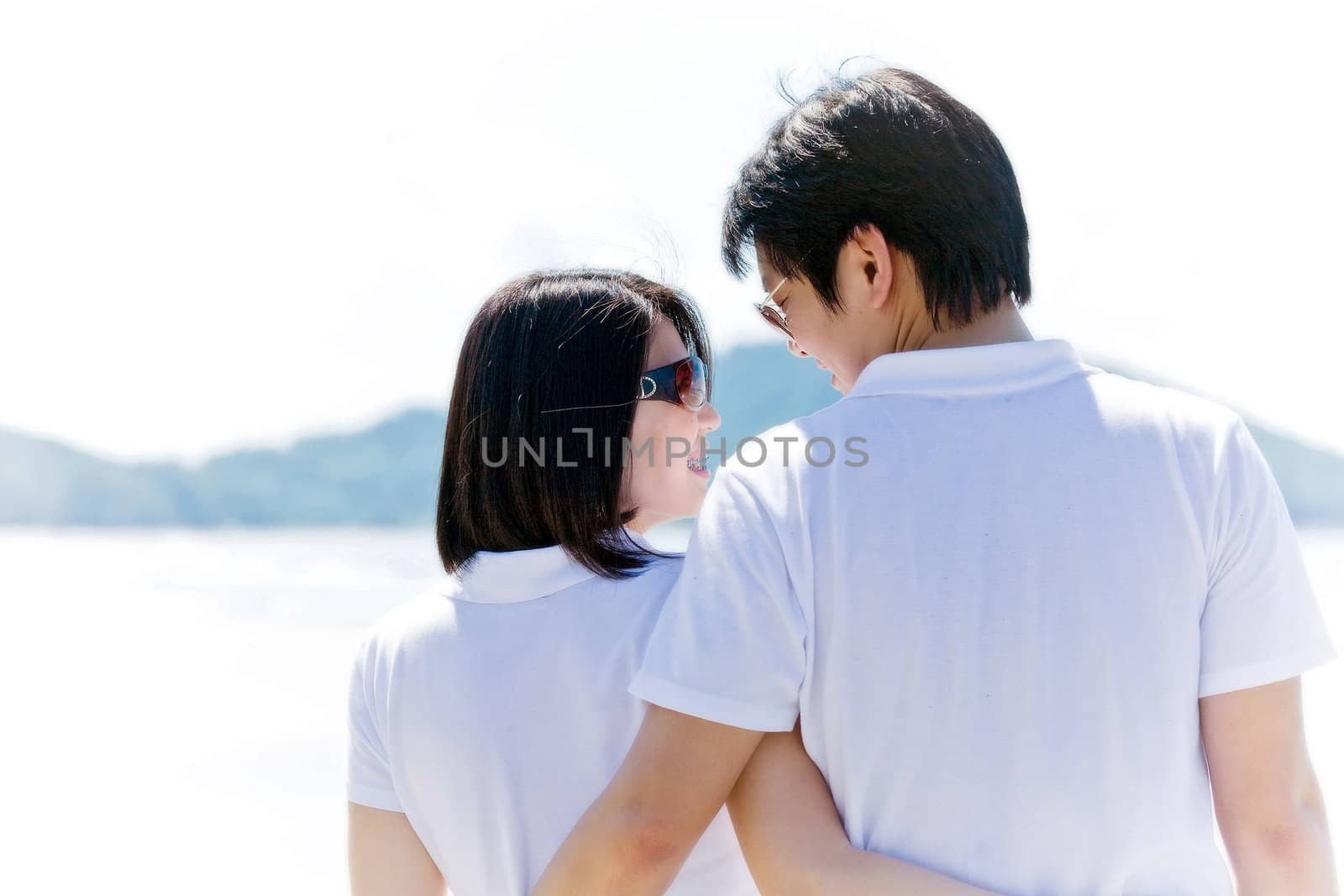 closeup of romantic couples, each other seeing eyes on the beach