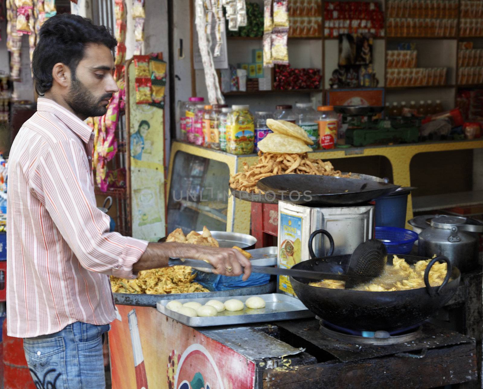 Jammu Kashmir, India - December 18, 2011: Portrait of a cook frying pakoras at a fast food and snack stall in Jammu Kashmir the Northern regions of India