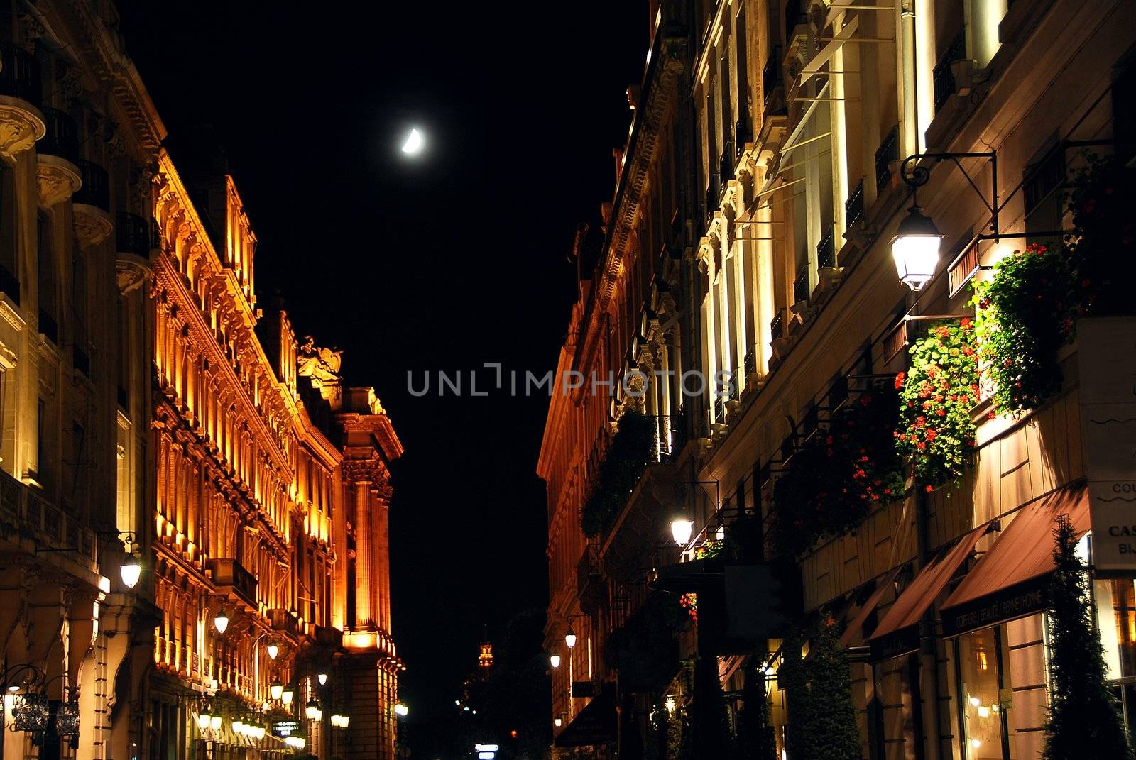 Illuminated street in Paris France with bright moon