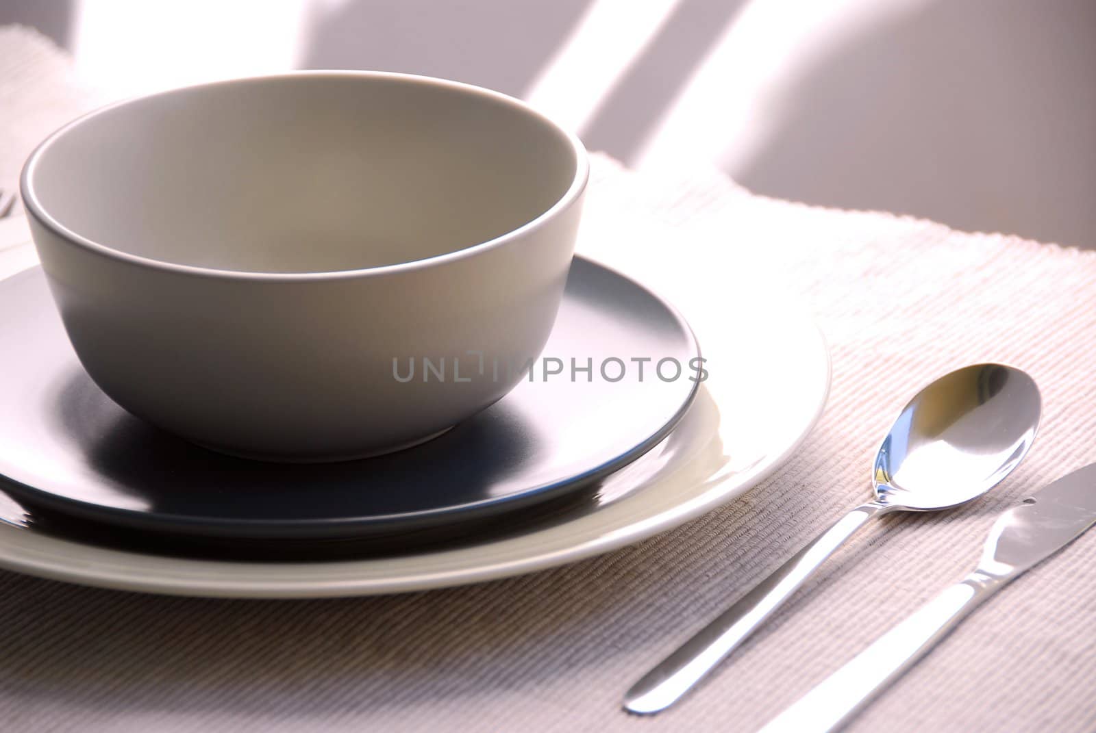 Dinner place setting with plates and soup bowl