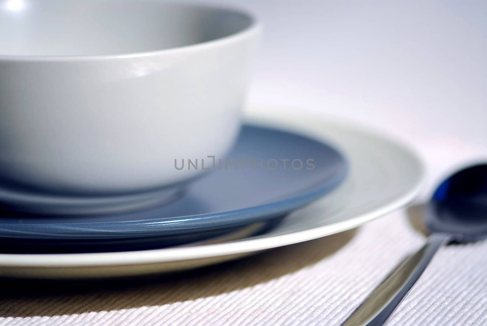 Dinner place setting with plates and soup bowl