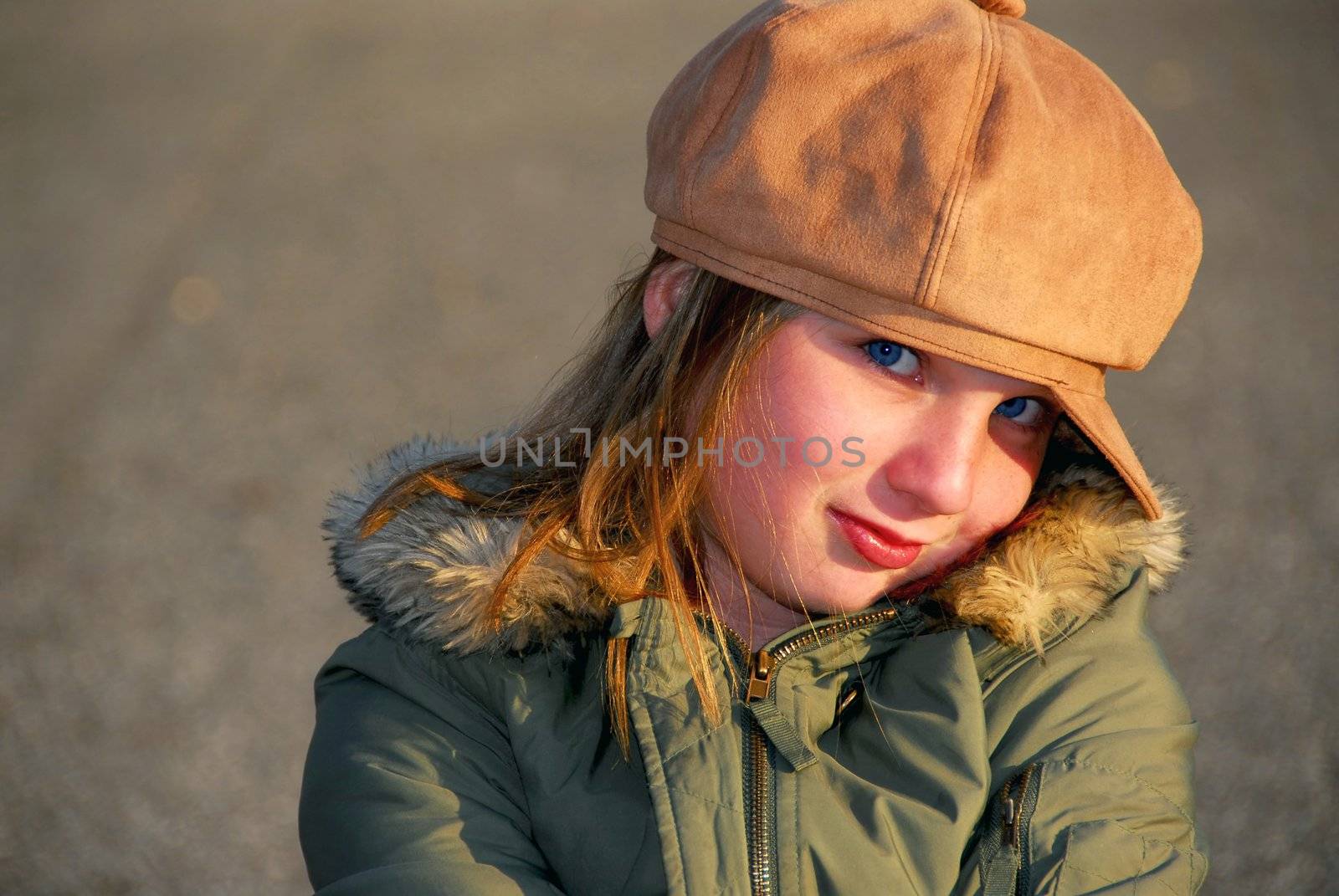 Portriat of a coy smiling girl in winter or fall clothes outside