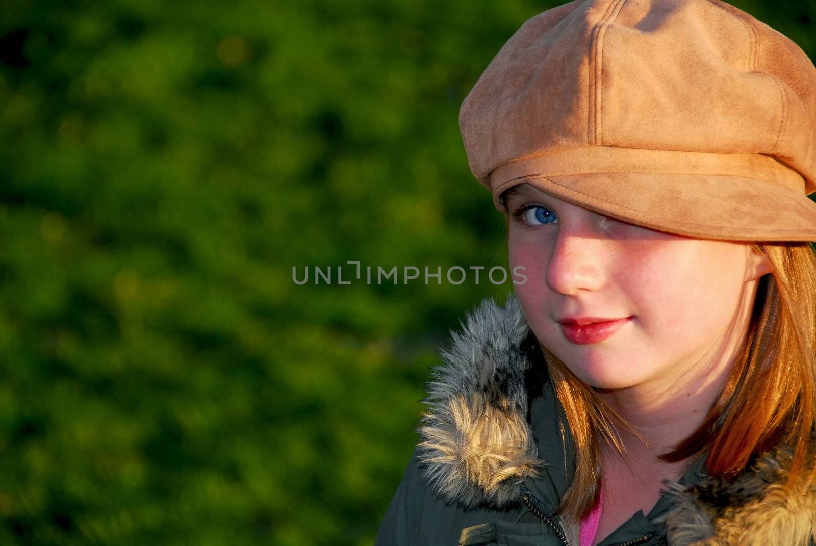 Portriat of a young smiling girl in fall clothes outside