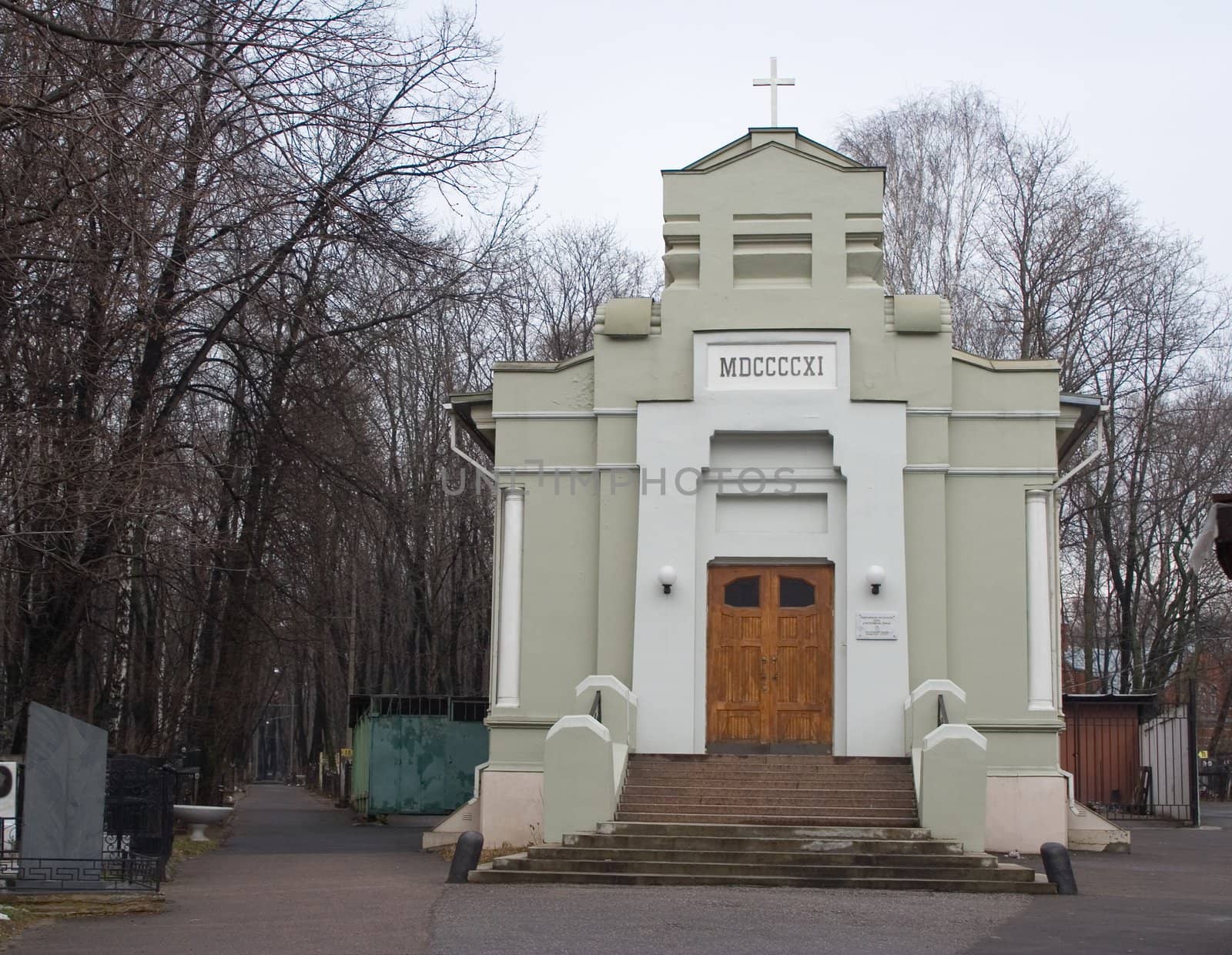 Small freshly painted Lutheran chapel on Vvedenskoe cemetery in Moscow on overcast winter day