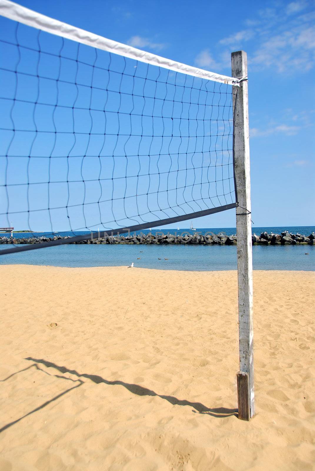 Beach volleyball net in perspective on a sandy beach