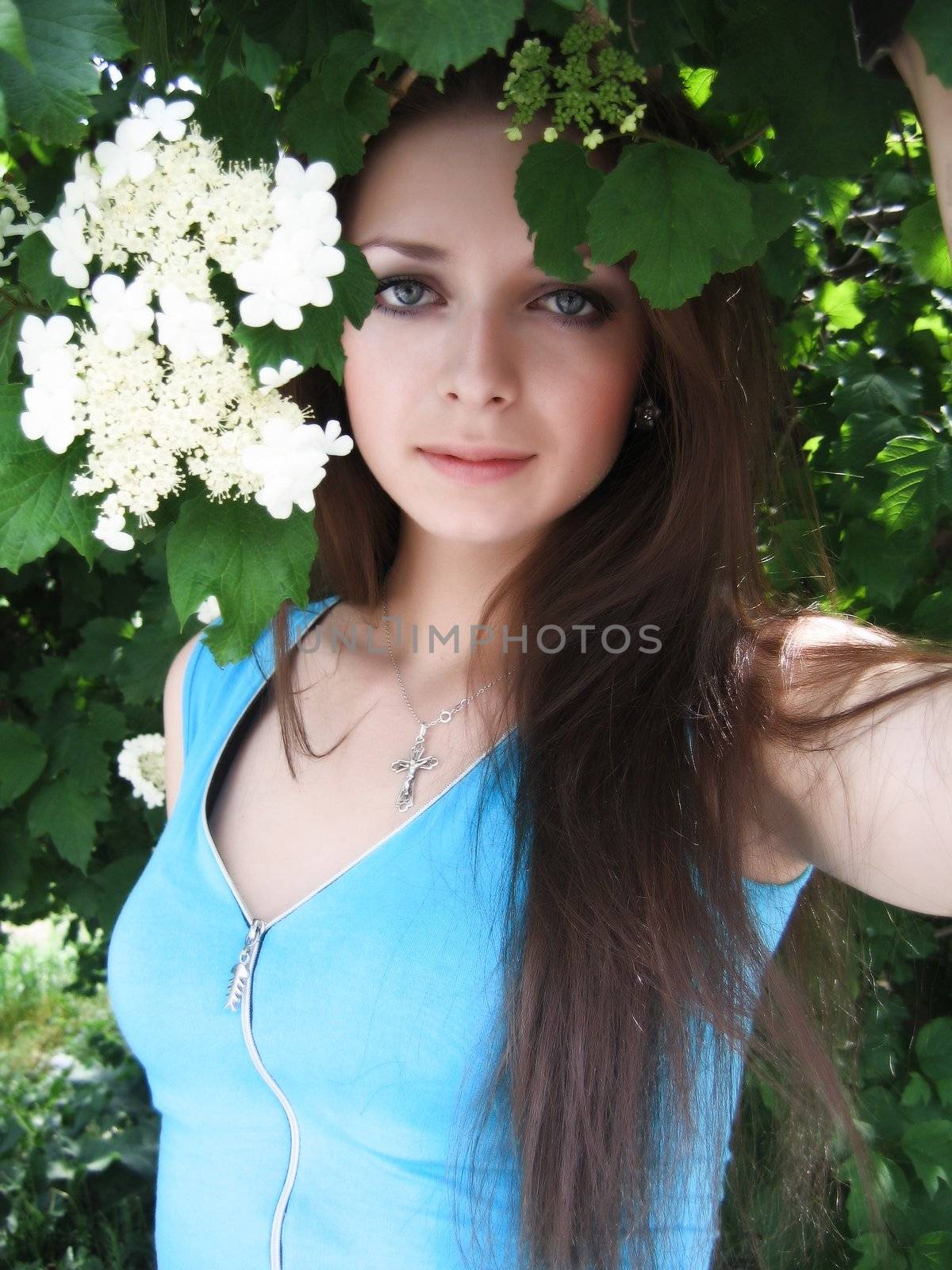 Long-haired beautiful girl in white flower blossom