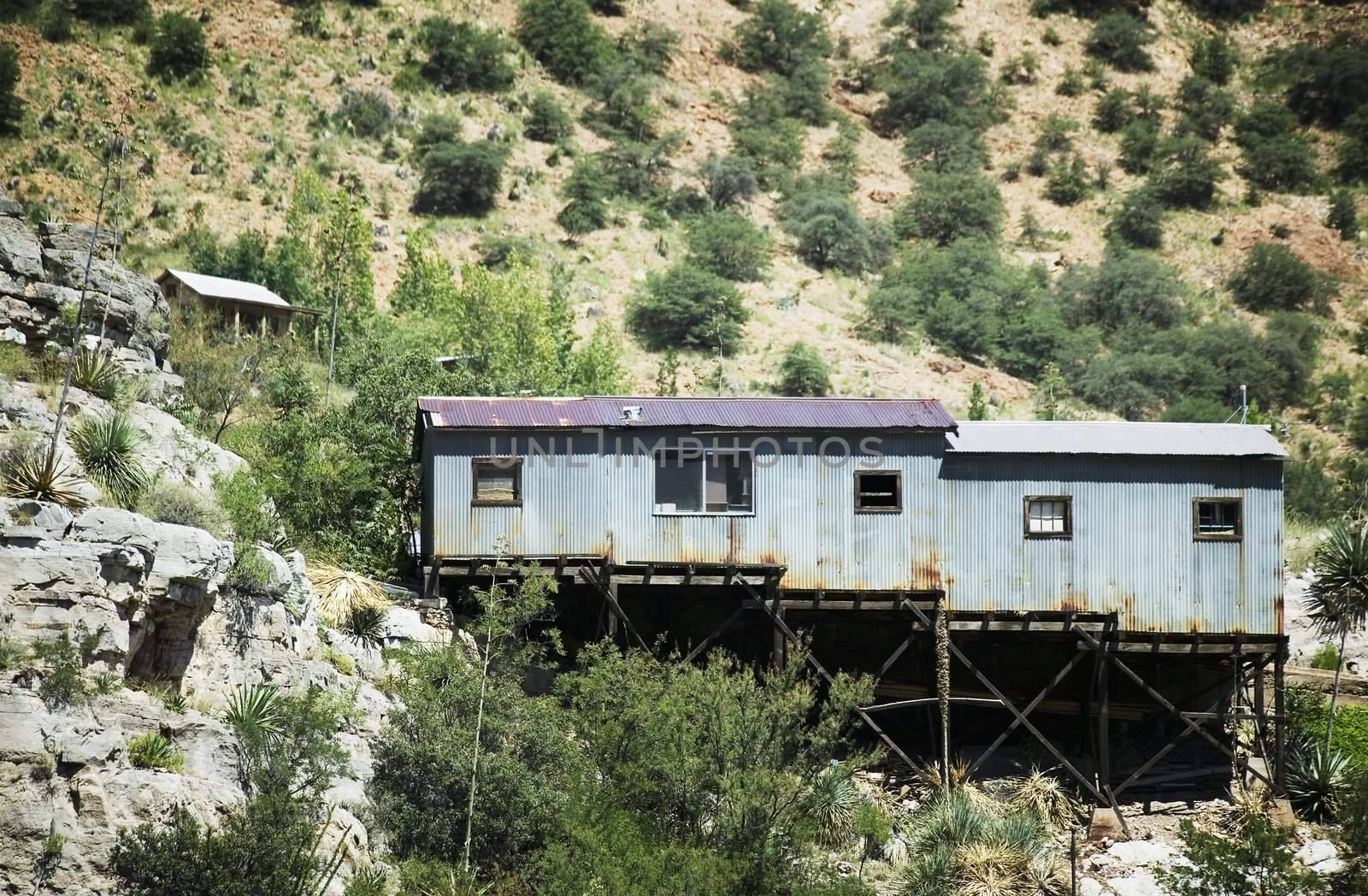 Corrugated metal miner's shack perched on an Arizona hillside.