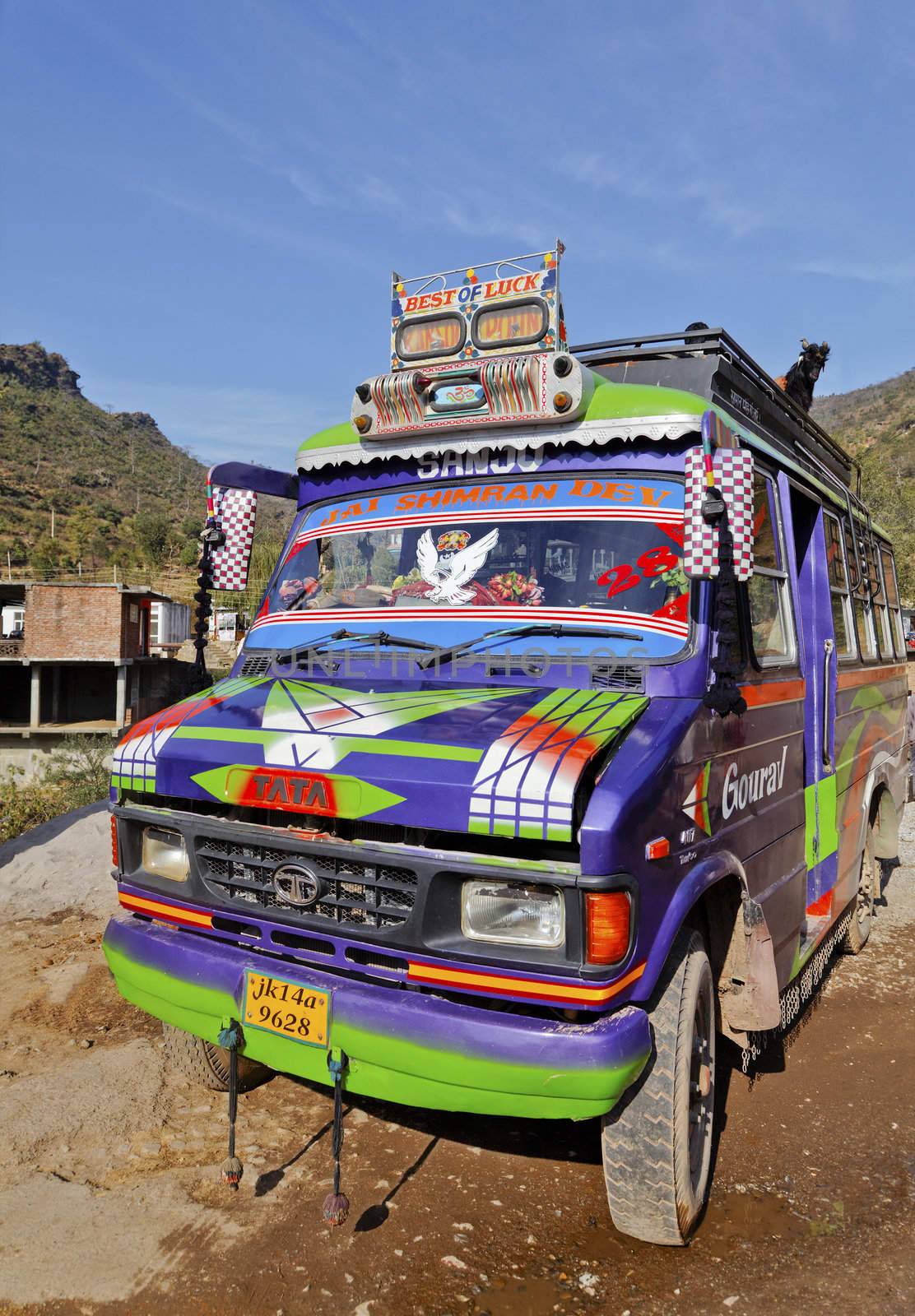 Shiva Kodi, Jammu Kashmir, India - December 18, 2011: Portrait, Brightly colored local transport and infrastructure in the jammu Kashmir Northern lowland mountianous regions of the Himalayas in India, will transport anything including goats on the roof rack