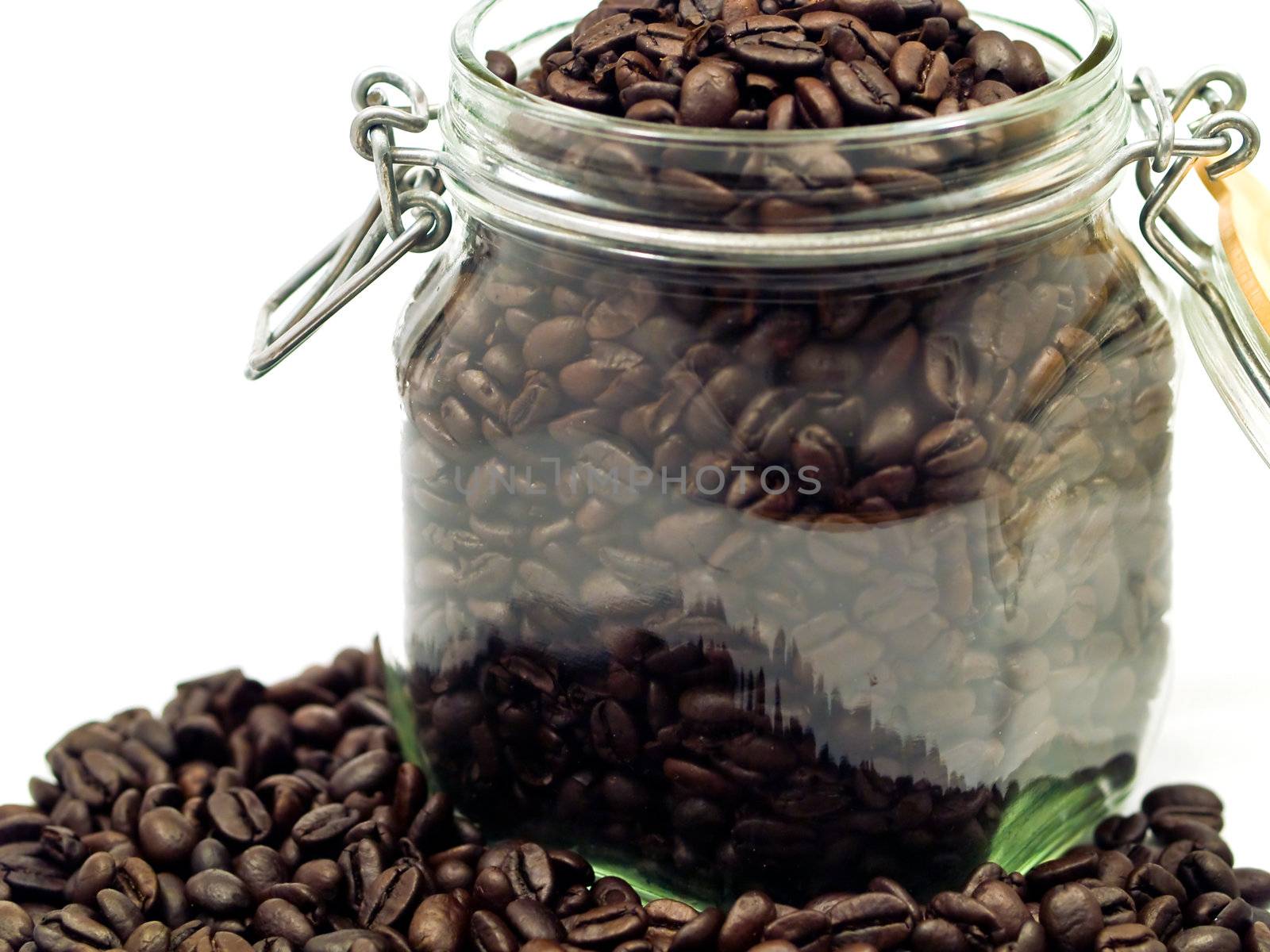 Coffee Beans and a Clear Glass Container with more Coffee