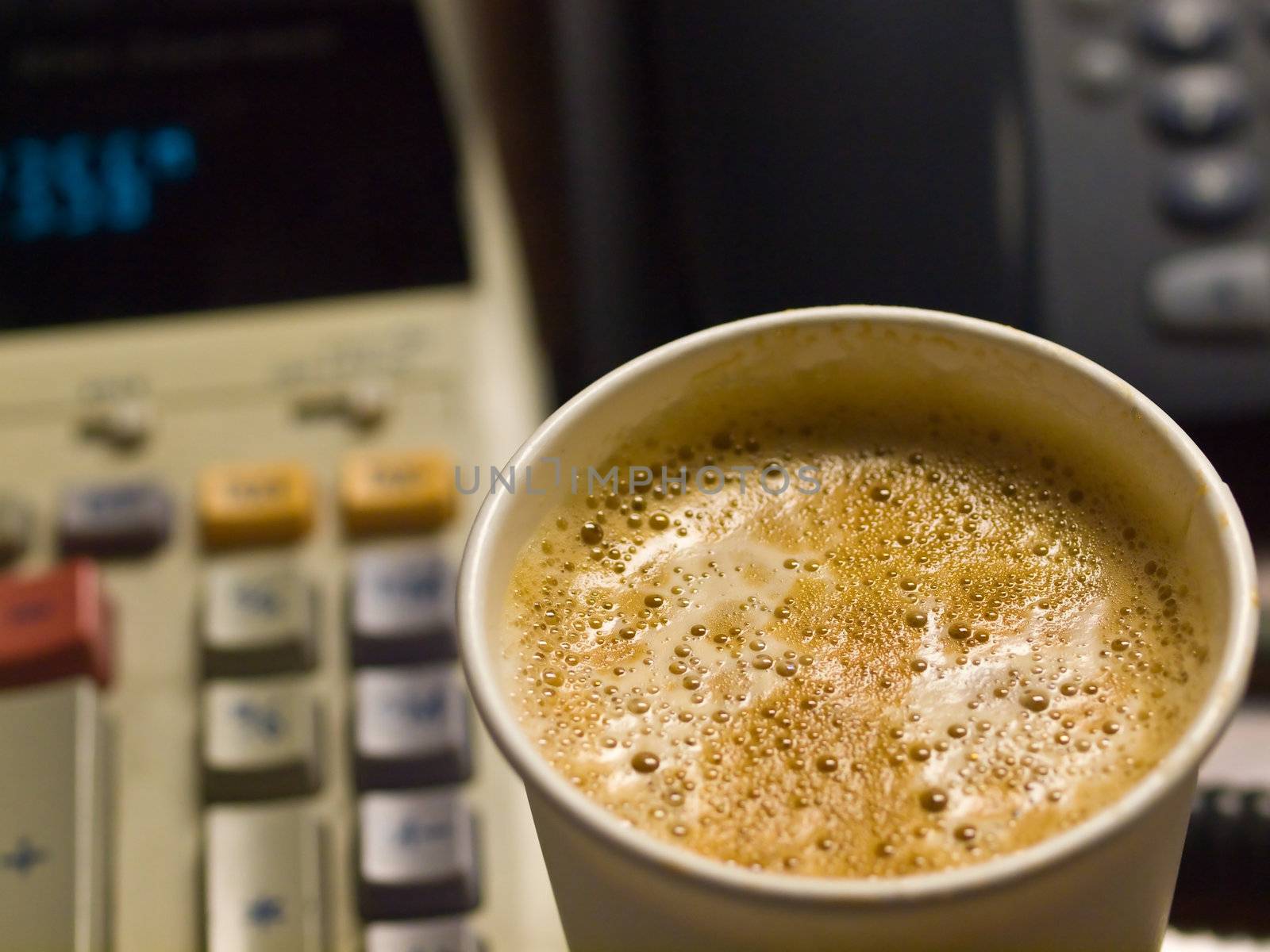 Cup of Coffee in a Paper Cup on a Office Desk