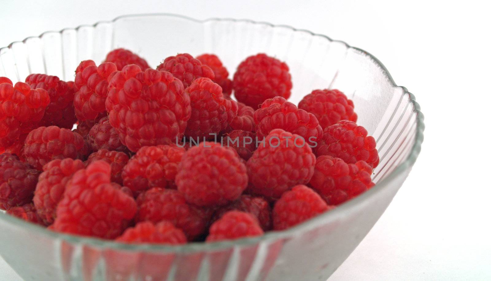 Raspberries Close Up in a Bowl on White