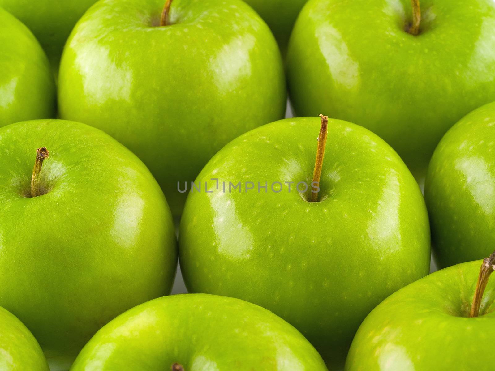 Green apples arranged in rows