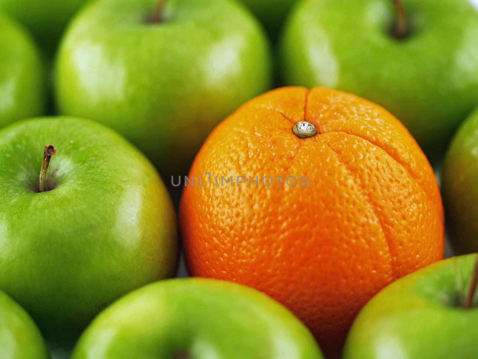 Green apples and one Orange