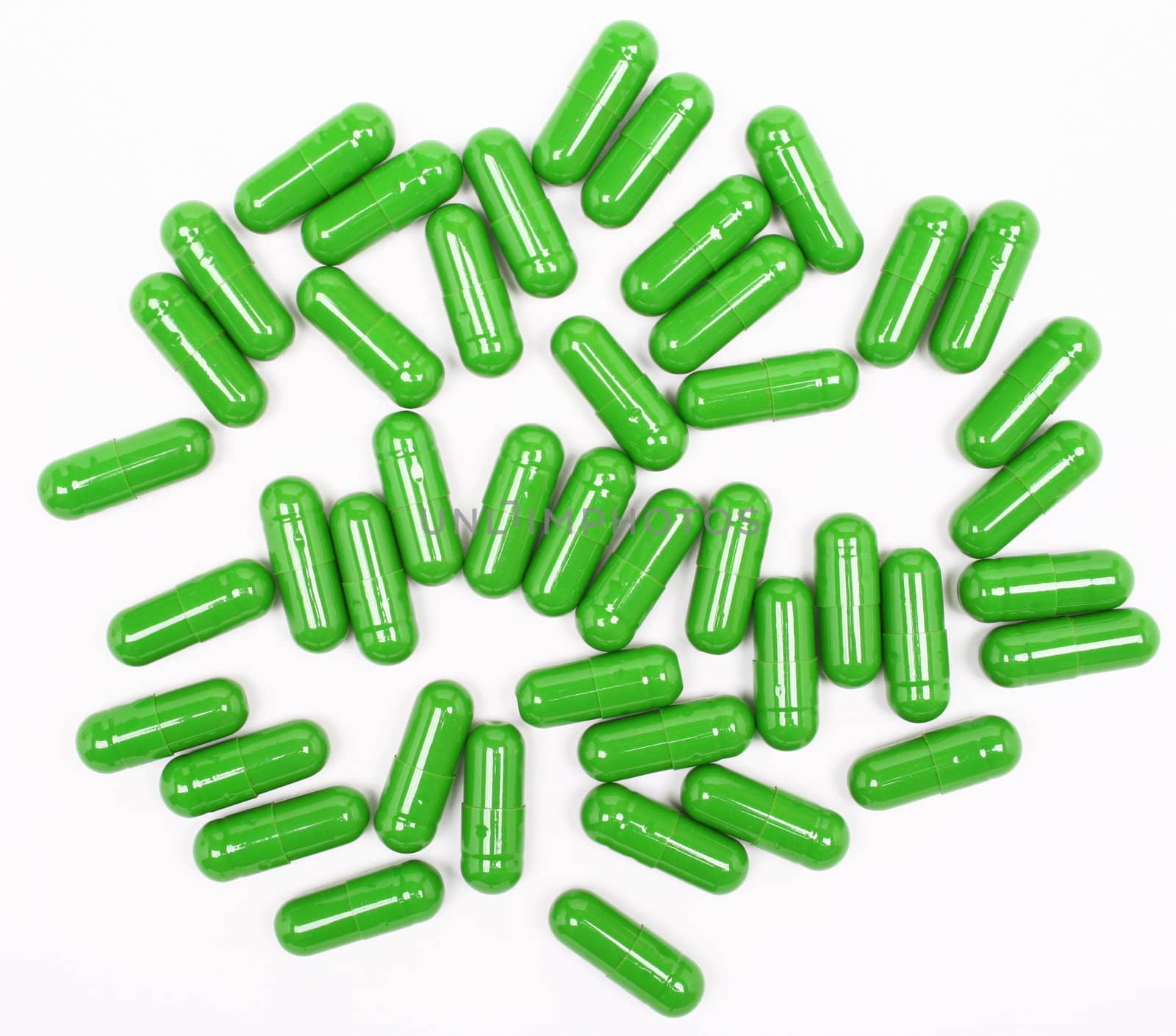 Green pills on white background 