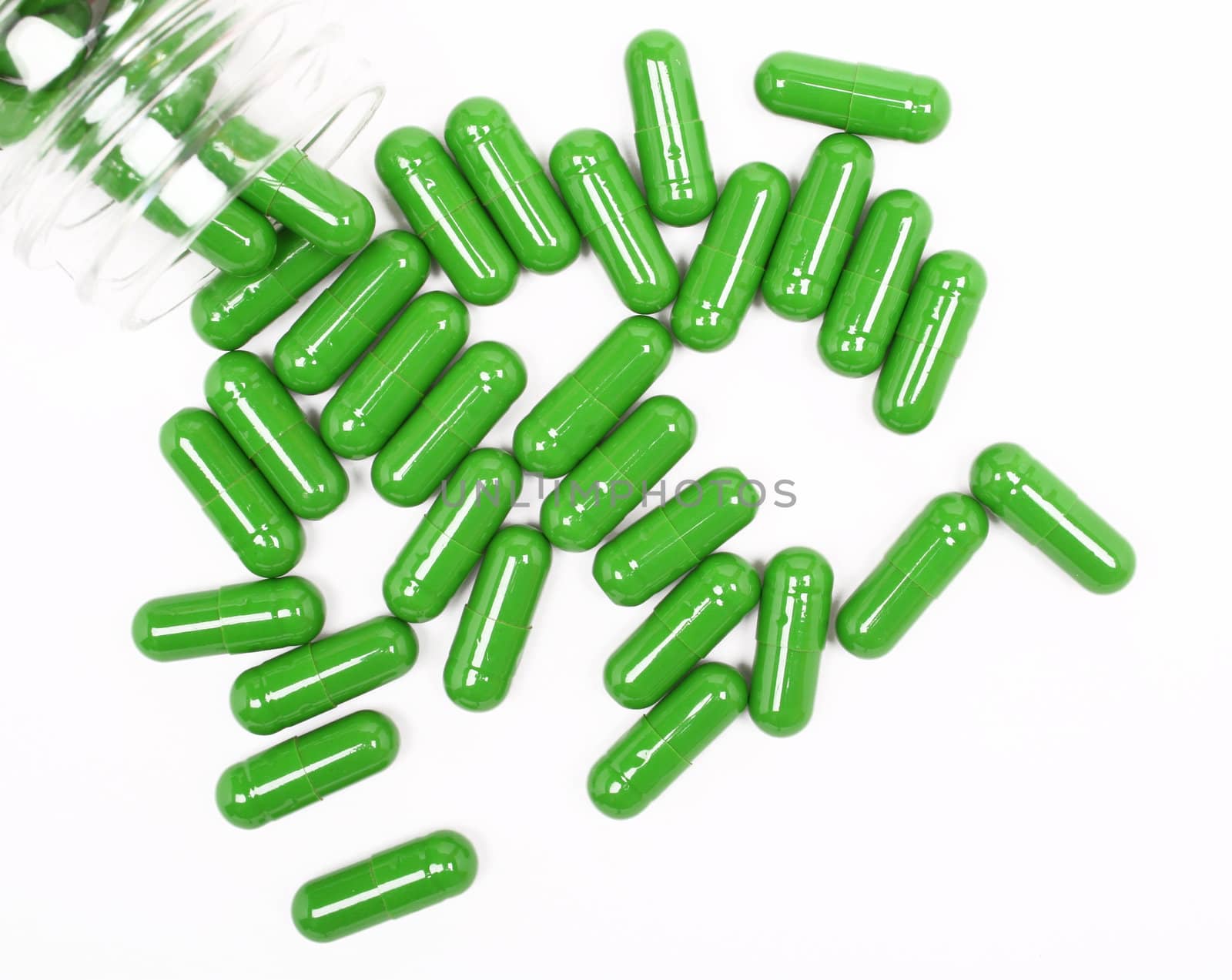 Green pills on white background