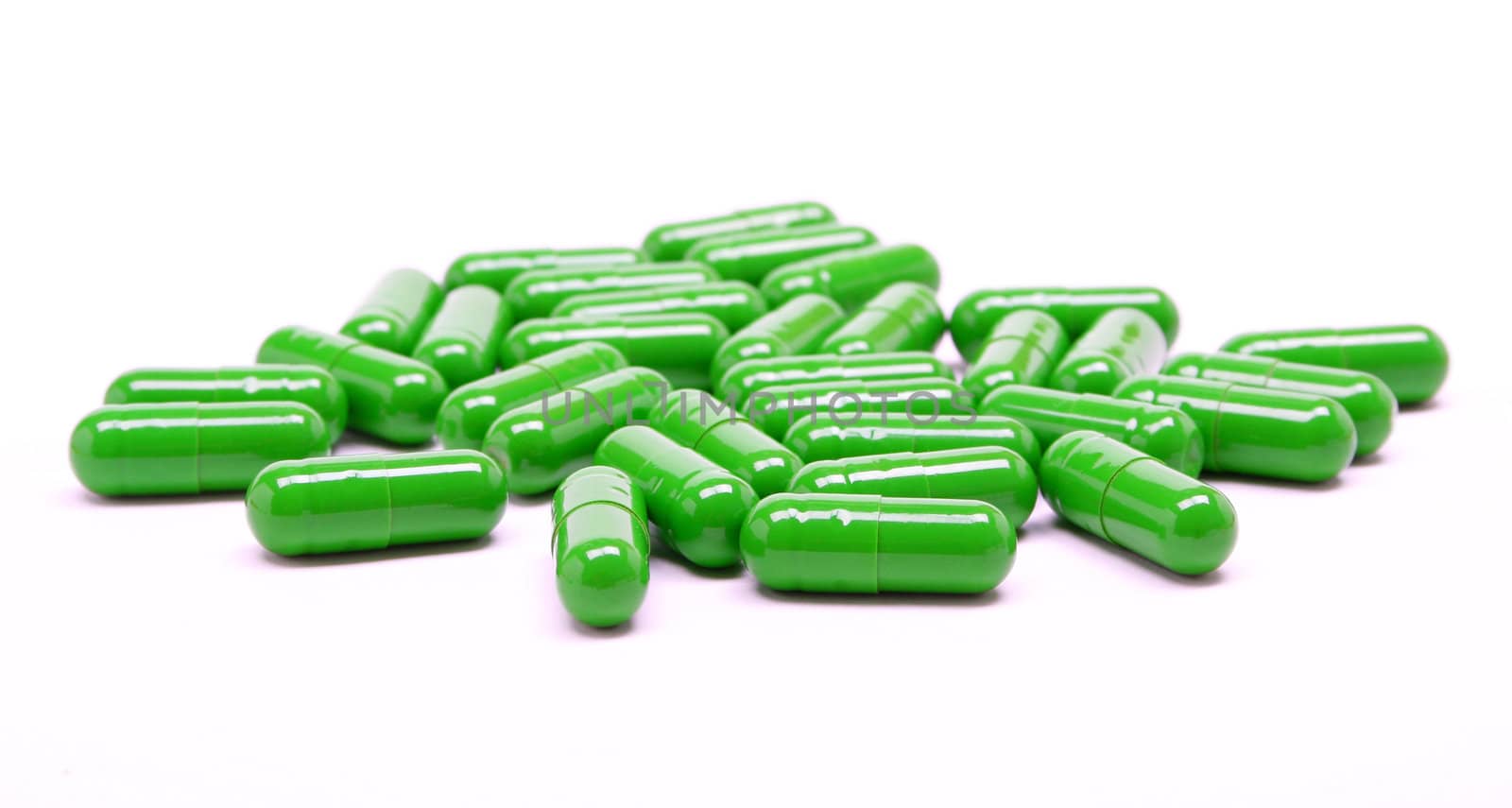 Green medical pills on white background 