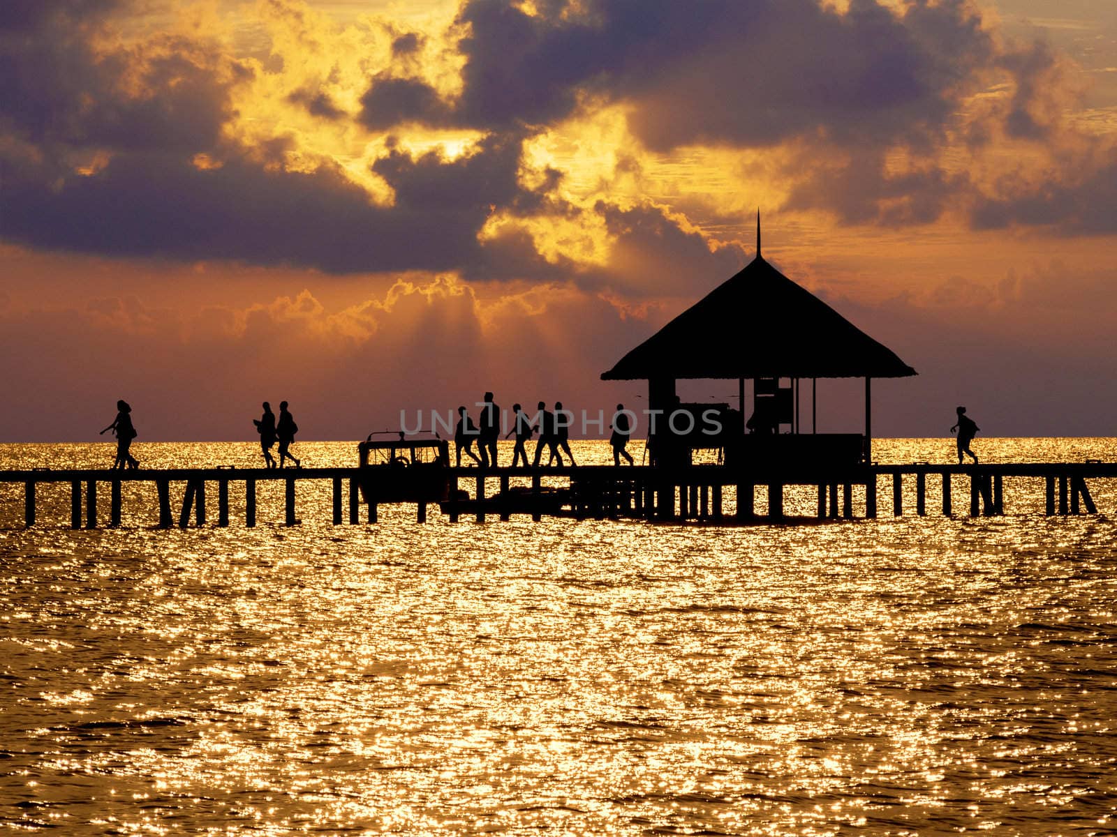 Boat dock in silhouette on small Indian ocean island
