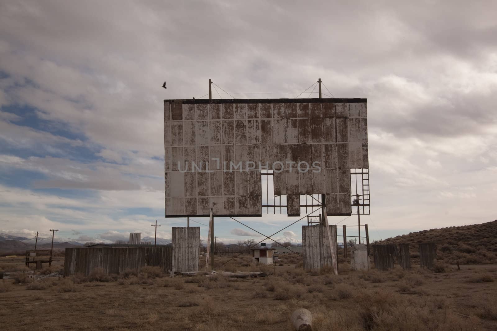 abandoned movie theater int he desert with clouds