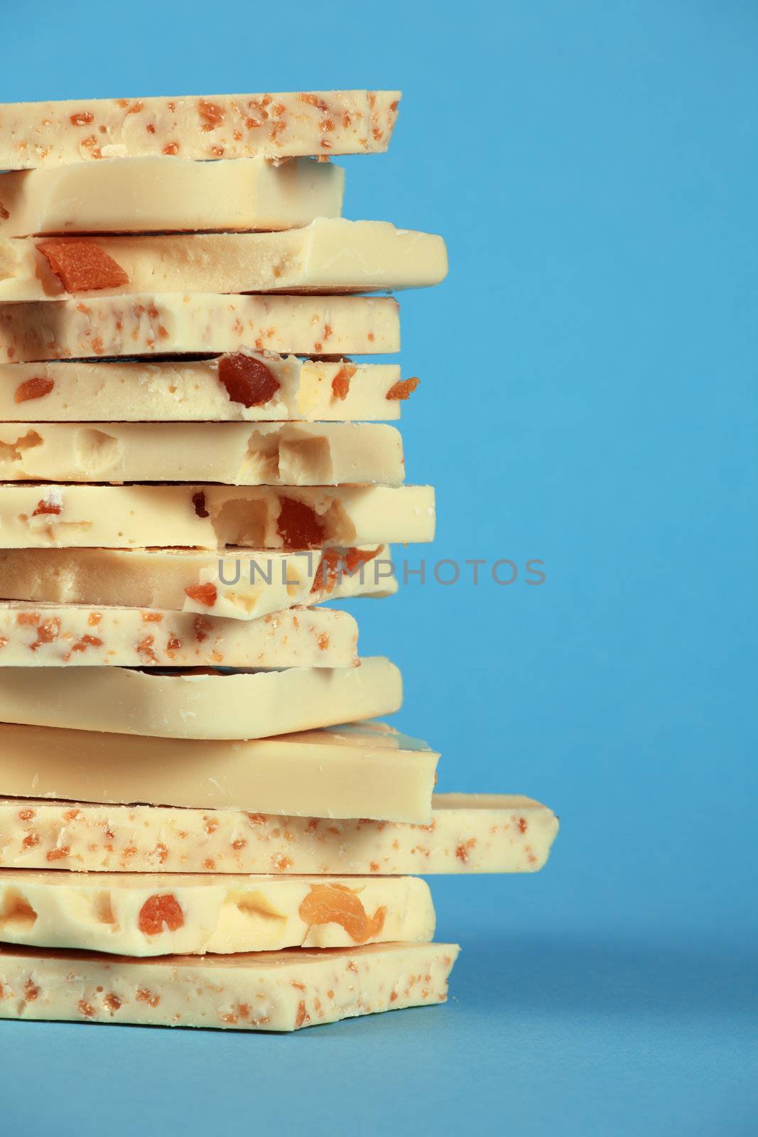 White chocolate stack on blue background by sumners