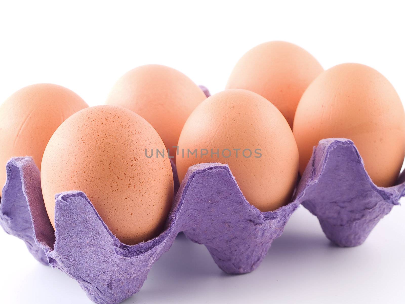 Six Brown Eggs in an Egg Carton Isolated on White