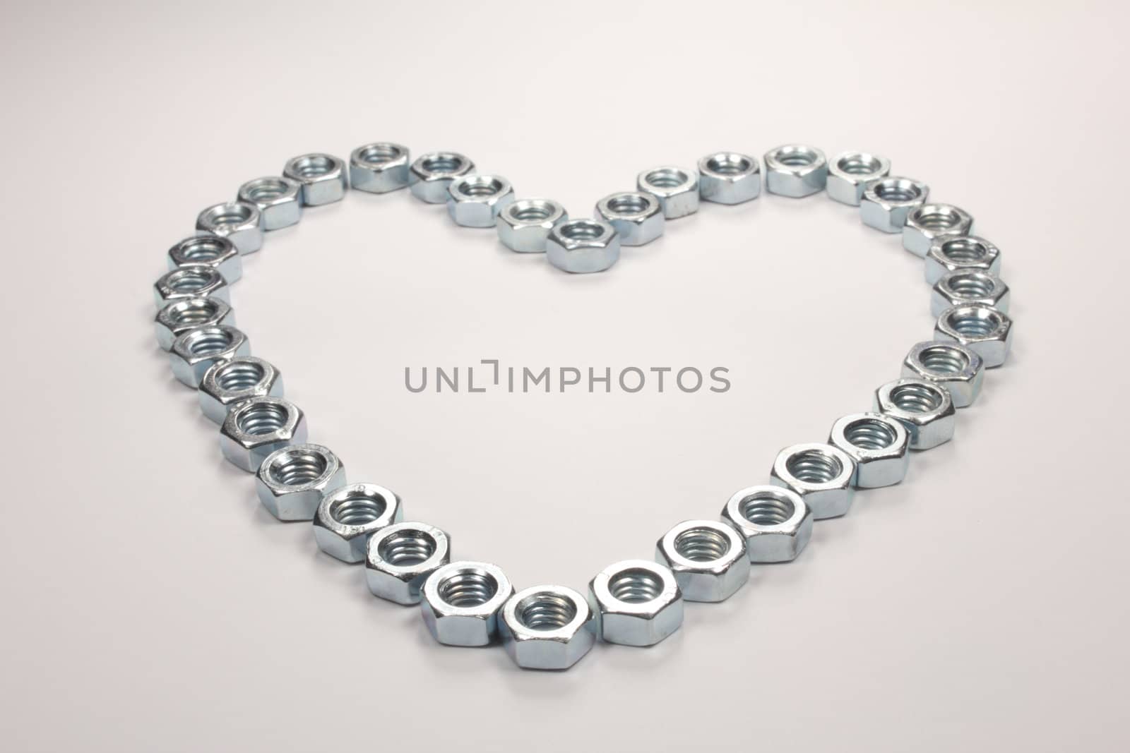 Heart of nuts on white background
