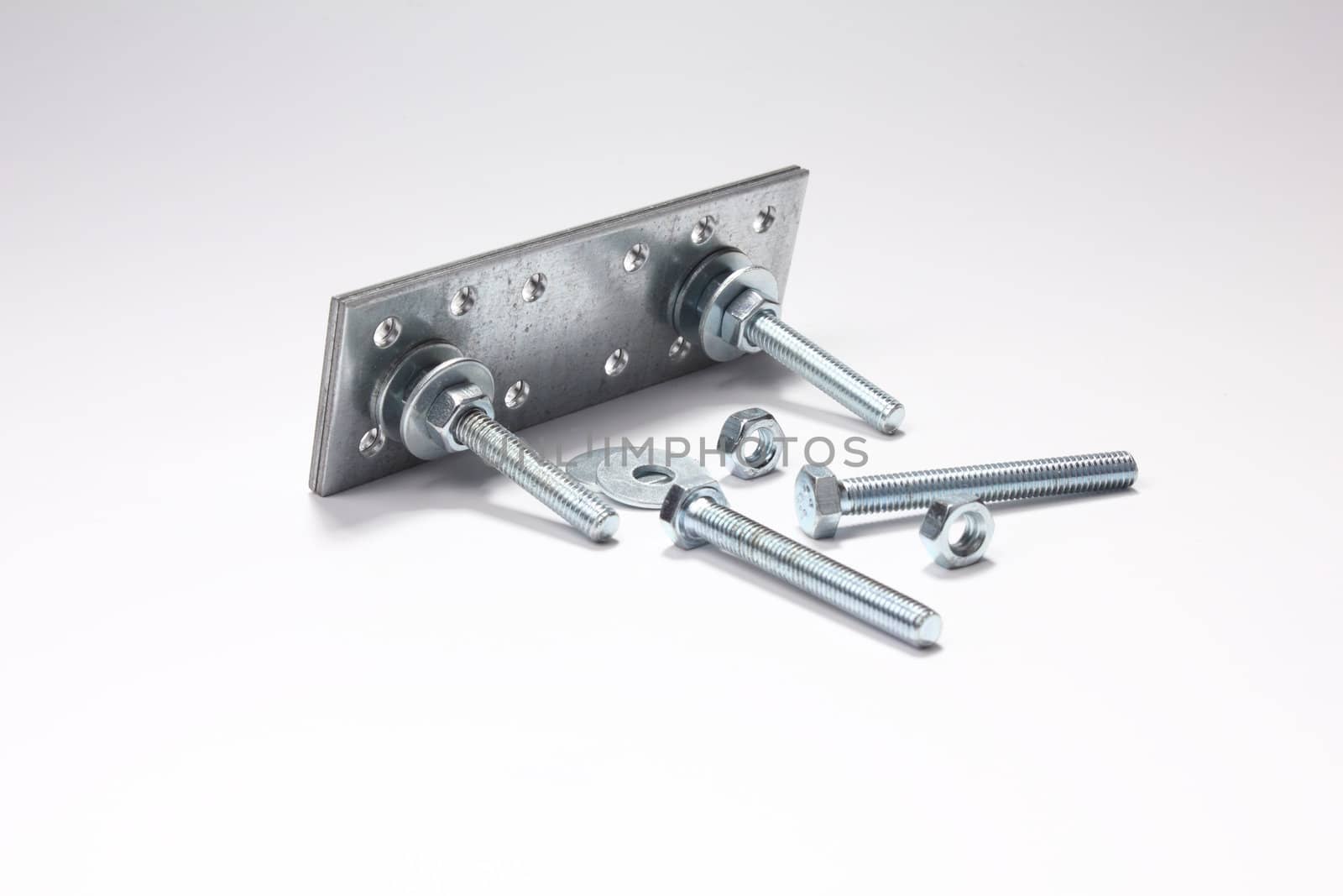 Construction of bolts, nuts, washers and plates on white background.