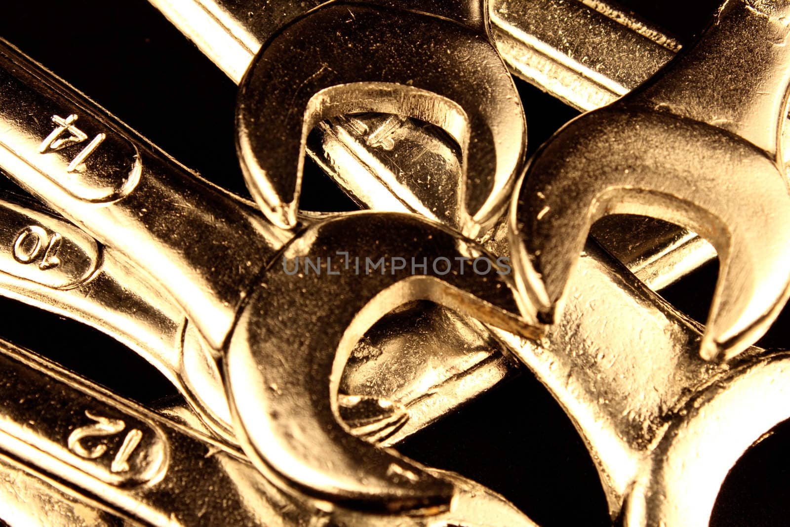 Set of wrenches on black background.