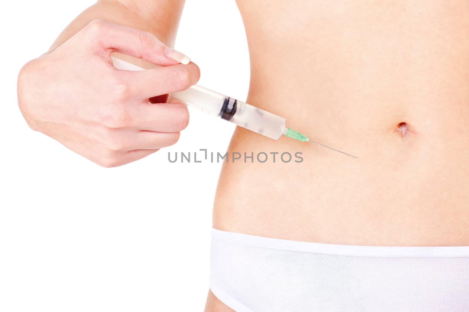 Syringe on woman's stomach, isolate on white. Health concept