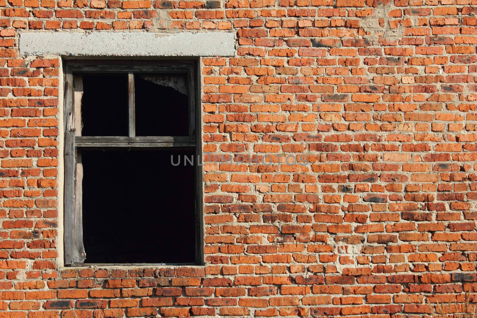 Old brick wall with broken wood window