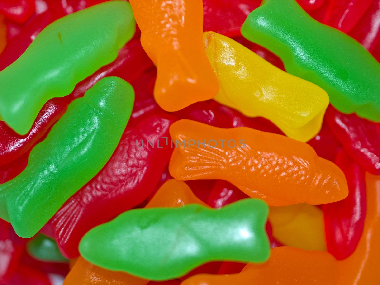 Colorful Gummy Candy Fish Background in Green, Red, Orange and Yellow