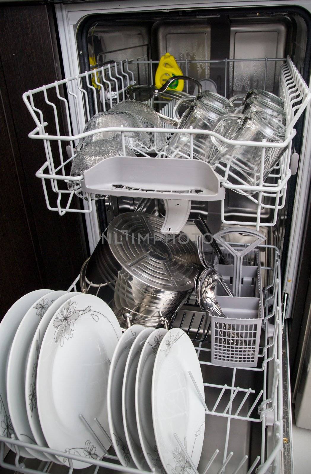 Dishwasher with white plates and glasses by simpson33