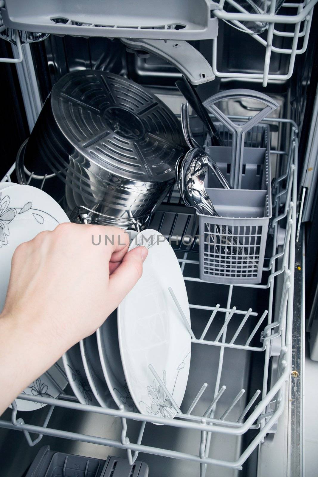 Hand takes plate from dishwasher by simpson33