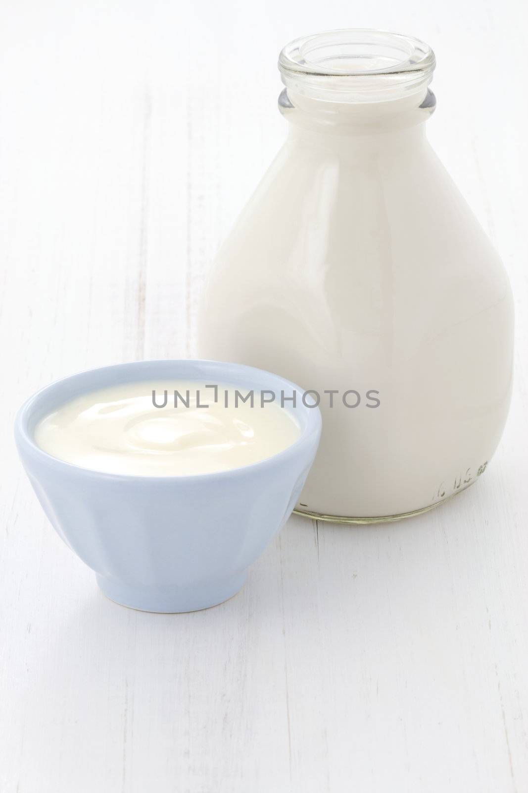 Delicious, nutritious and fresh plain yogurt and milk bottle.