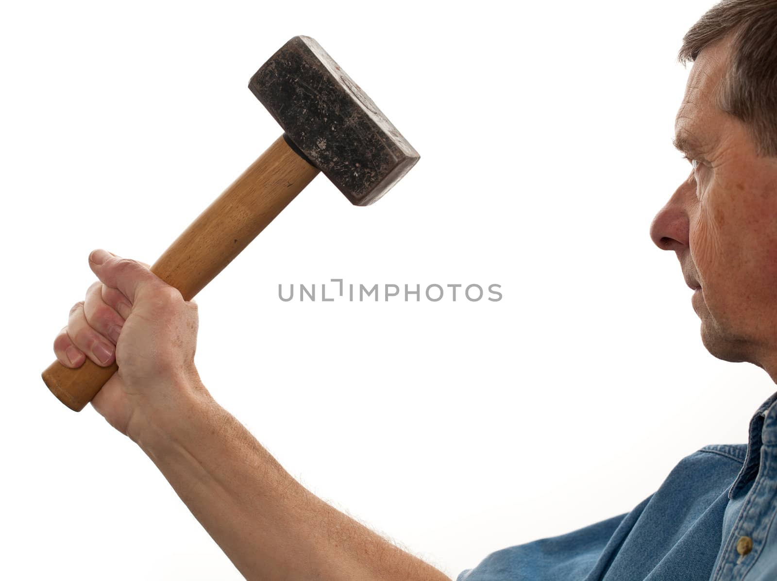 Senior male holding a large lump hammer isolated against white